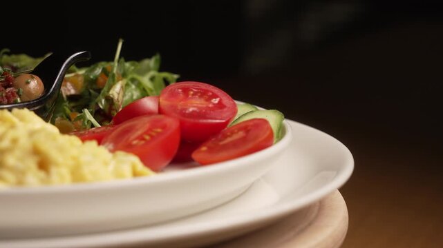Delicious and healthy Turkish breakfast plate with assorted cheeses, scrambled eggs, and fresh vegetables, fa01