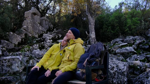 Young travelers discover ancient amphitheater and ruins of Termessos. Walking, climbing, enjoying view and ancient history in warm Turkish light.