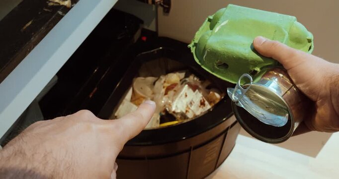 Man pointing at trash and showing that carton and metal packaging should not go into regular waste, highlighting recycling rules and environmental awareness.