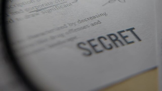Magnifying glass enlarge rubber stamp label of security clearance Secret on official government classified looking report or document. Leaked exposed confidential file with sensitive spy information