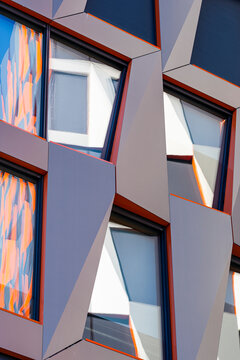 Geometric modern building architecture facade with angles windows and abstract reflection forming a striking pattern background for creative design