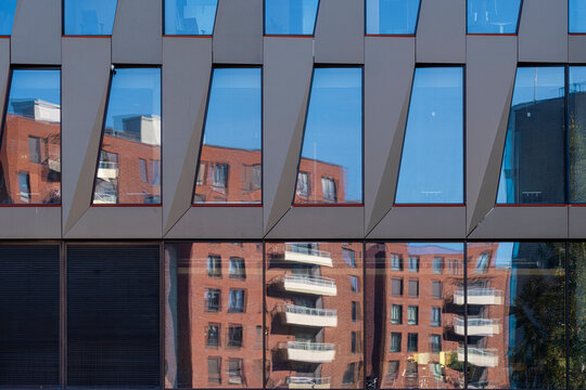 Abstract reflection on modern urban building architecture facade where windows fins and pattern create a sharp geometric background texture