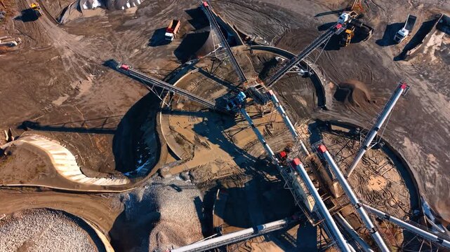 Construction site with machinery. Heavy machinery works at a construction site during the day. Various trucks and equipment are present.