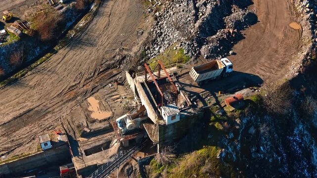 Site with truck and equipment. A truck is at a construction site where workers are using heavy equipment to move materials during the day.