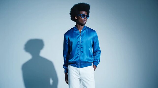 Stylish Black man in blue bomber jacket and sunglasses