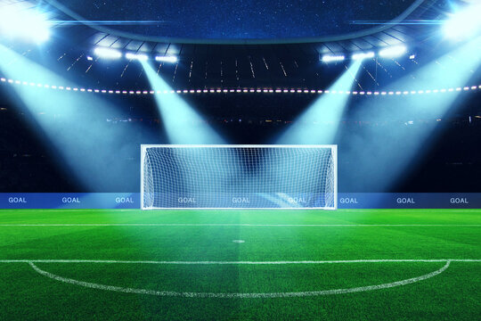 professional football goal stands empty on a lush green pitch under powerful stadium spotlights at night. Sporty win atmosphere with lens flares and a starry sky. world cup, concept. Creative sport