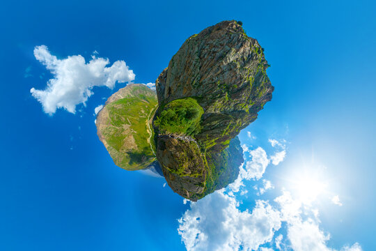 Rugged mountain peaks under bright blue sky, little planet hyperbolic projection.