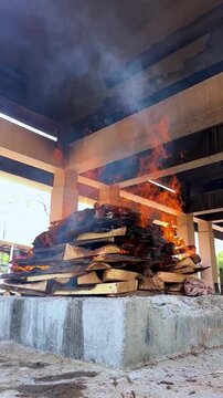 Hindu Cremation Ritual with Burning Pyre at Traditional Cemetery
