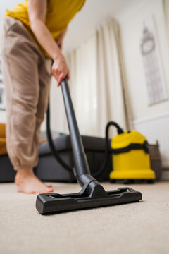 Vacuuming the floor. Close up of vacuum cleaner, living room. Household and useful technology lifestyle. Copy space