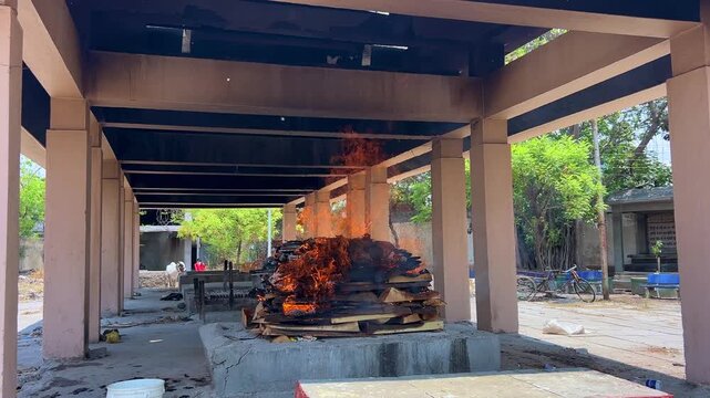 Hindu Cremation Ritual with Burning Pyre at Traditional Cemetery