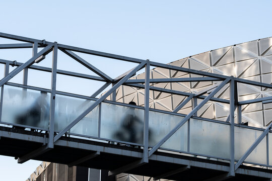 Modern bridge crossing in Stockholm Sweden shows bicycle commute transport above urban city street where cycleway infrastructure mobility signals sustainable city planning