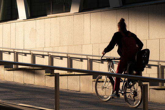 Late afternoon ramp scene in Stockholm Sweden with bicycle commute transport through urban city street as cycleway infrastructure mobility shapes sustainable routines