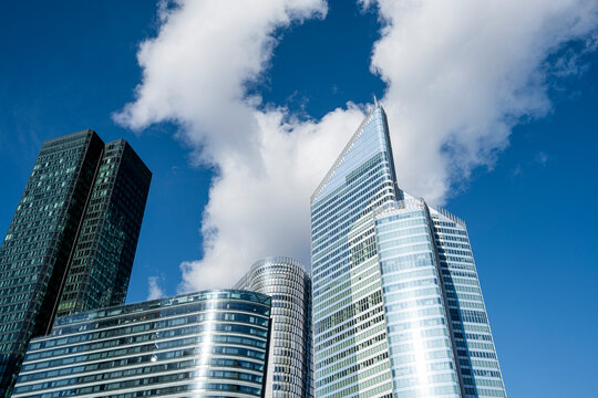 Clouds over La Defense paris as modern glass towers define skyline and urban architecture supporting finance business district panorama view