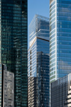 Vertical glass towers in La Defense paris shape skyline with modern urban architecture for finance business district and real estate power