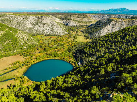 Aerial view of the confluence where the Cikola river lake drom torak view tributary joins the Krka river canyon, Krka National Park, Dalmatia, Croatia.