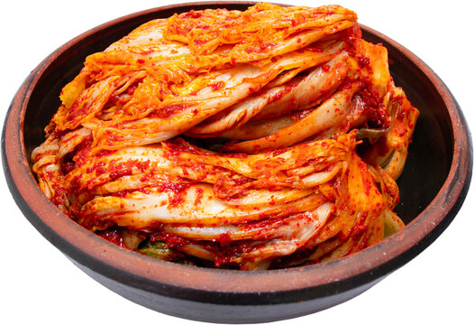 Napa cabbage kimchi in traditional brown earthenware bowl isolated on transparent background, PNG
