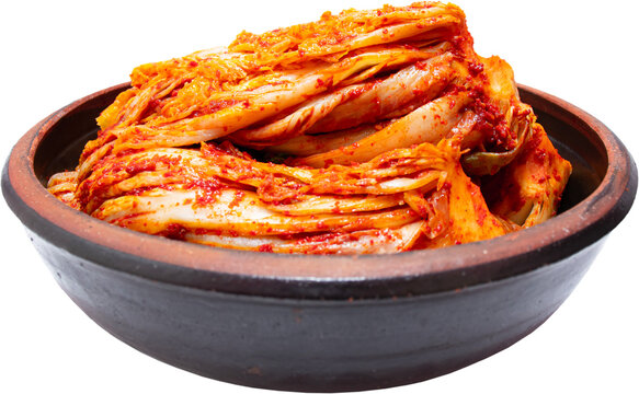 Napa cabbage kimchi in traditional brown earthenware bowl isolated on transparent background, PNG