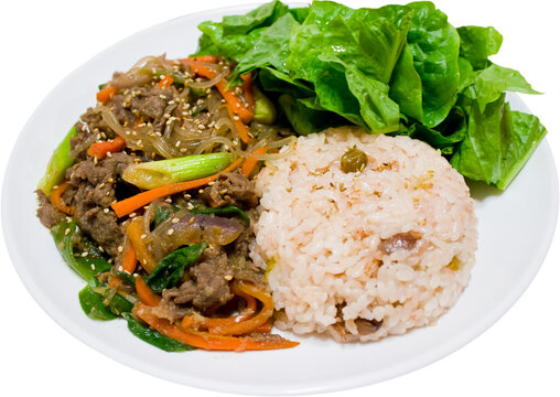 Beef bulgogi with rice and lettuce on round white plate isolated on transparent background, PNG, Korean marinated beef dish with sweet and savory flavor.