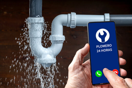 Leaking sink pipe and emergency plumber call on smartphone for home repair.