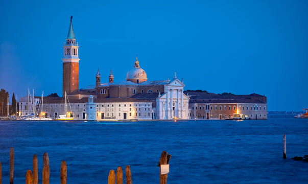 Venice, Italy. Panoramic View at island and Basilica di San Giorgio Maggiore. Blue hour evening time over old town Adriatic Sea. Famous location in Venezia view from Saint Mark square.