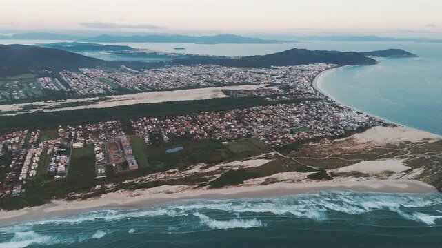 Aerial view of the town of Ingleses and its dunes during sunrise on the island of Santa Catarina. Florianopolis, Brazil