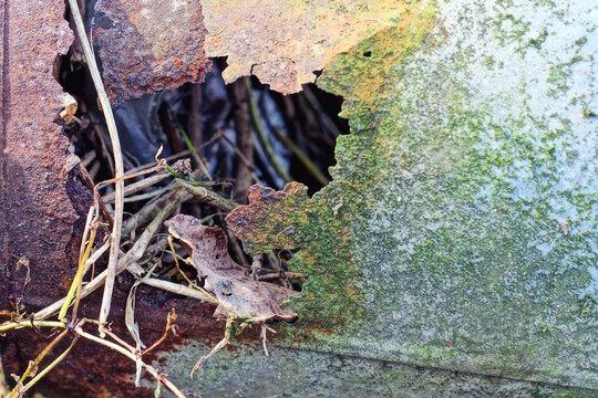 metal texture from a piece of old iron in brown gray rust with a hole