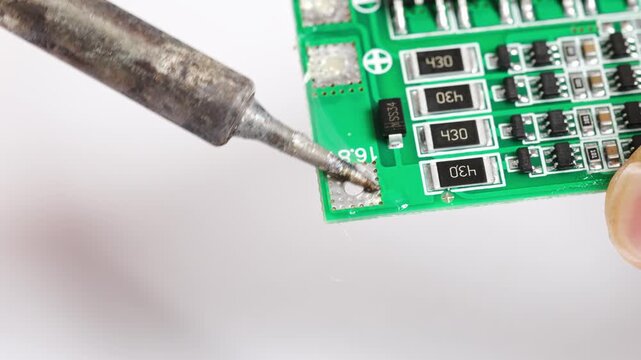 Repairing electronics with soldering techniques at the workshop