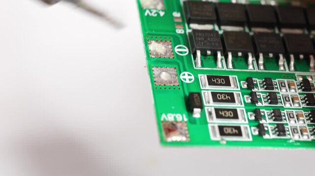 Repairing electronics with soldering skills at a workshop