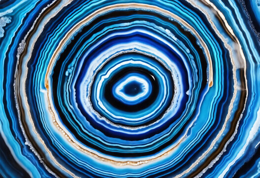 Concentric blue agate bands display striking mineral formations. This geological wonder showcases intricate, swirling patterns of vibrant blue hues.