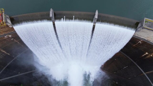 Close-up Aerial View Of Water Cascading Over Curved Dam Spillway - Encoro do Eume In Galicia, Spain. tilt-down shot