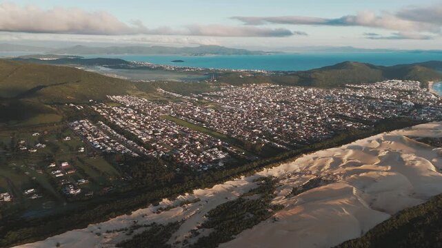 Aerial view of the town of Ingleses and its dunes during sunrise on the island of Santa Catarina. Florianopolis, Brazil