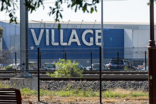 "VILLAGE" signage on the wall of a Village Cinemas multiplex building in Sunshine, Melbourne, Australia. Village Cinemas is an Australian-based multinational film exhibition brand