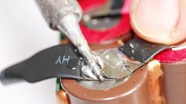 Repairing electronics using soldering techniques in a workshop