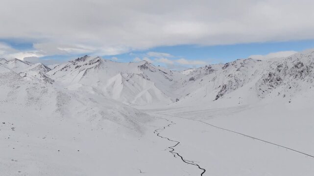 Aerial panoramic view of snowy Andes mountains in Las Lenas valley during winter, remote natural landscape.