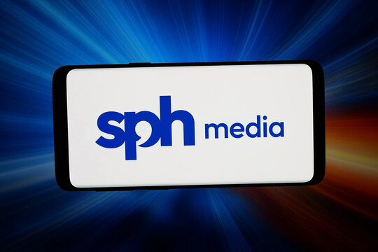 Stuttgart, Germany - 04-13-2026: In this photo illustration, the logo of Singaporean company SPH Media Limited is displayed on a smartphone in front of abstract background on computer screen.