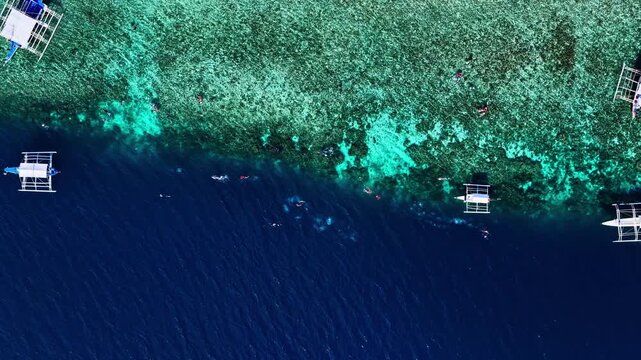 Amazing contrast of deep blue ocean and shallow coral reef in Moalboal