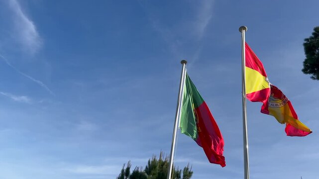 Wavy Spain and Potugal Flags and Clear Blue Sky