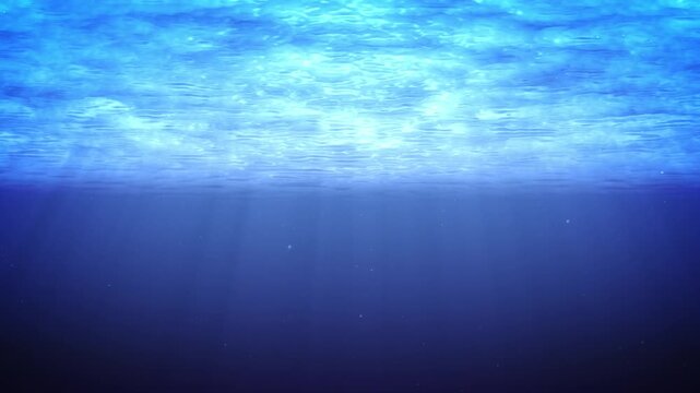 海中 背景素材 太陽の光が差し込む深い青い海 水面 幻想的 / Underwater background deep blue ocean with sunbeams filtered through water surface ethereal