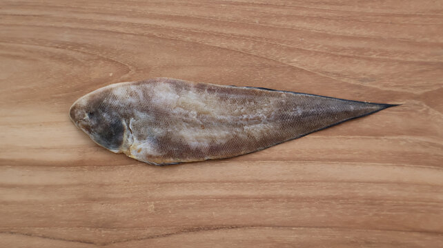 Dried Salted Flatfish on Wooden Surface
