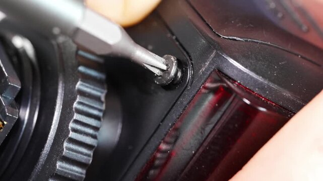 Repairing electronics with a screwdriver in a local workshop