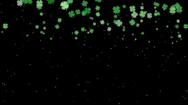 Falling green shamrock clover over isolated black background