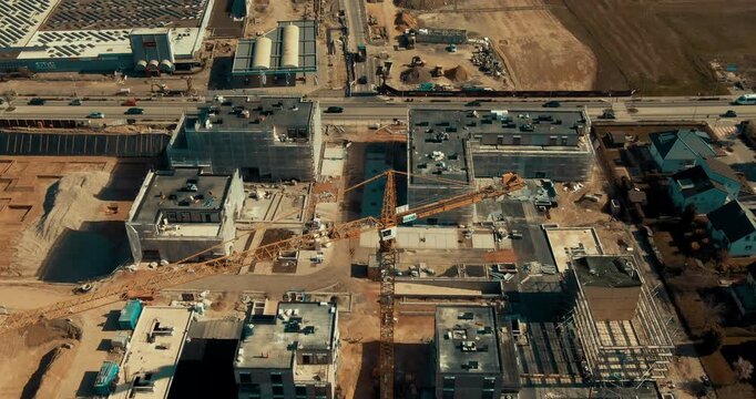 Low angle aerial view of residential building under construction with safety netting and scaffolding