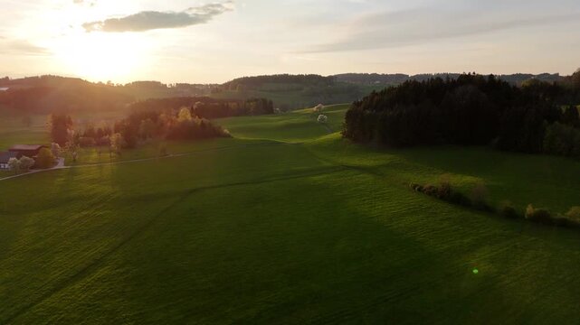 Aerial Drone Pullback Over German Countryside at Sunset with Fields and Distant Horizon, Slow Reveal Landscape