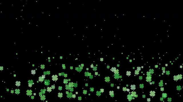 Falling green clover shamrock Irish holiday black background