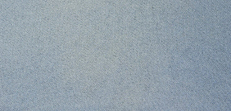 Sky blue fabric texture background, seamless pattern of natural textile. Close-up of cashmere scarf with lint.