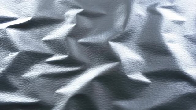 Time lapse close up of fabric forming wrinkles and creases on studio tabletop with static camera and controlled lighting