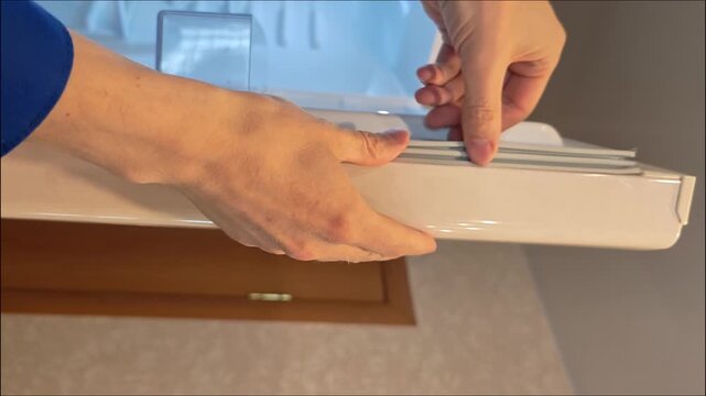 the repair service technician inspects the condition of the rubber door seal of the refrigerator at home