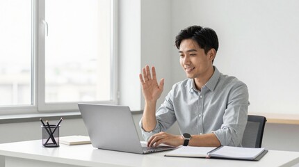 Fototapeta premium Engaged Young Man Waves During Online Meeting at Modern Workspace