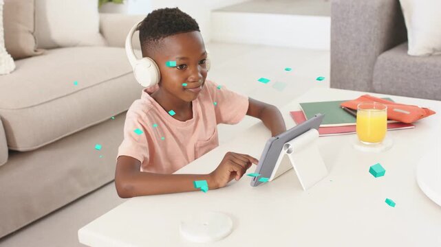Child tapping tablet at table causing animated teal graphics floating around child for education