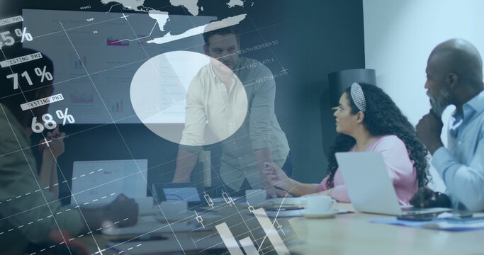 Presenting mid adult male leaning on table at meeting room, wearing light shirt with projected map